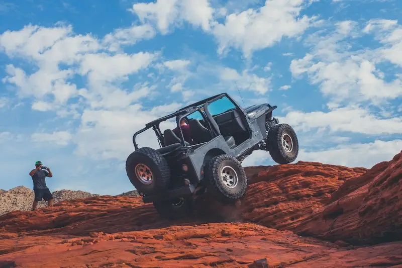 4x4 vehicle climbing over rocks on a ridge track