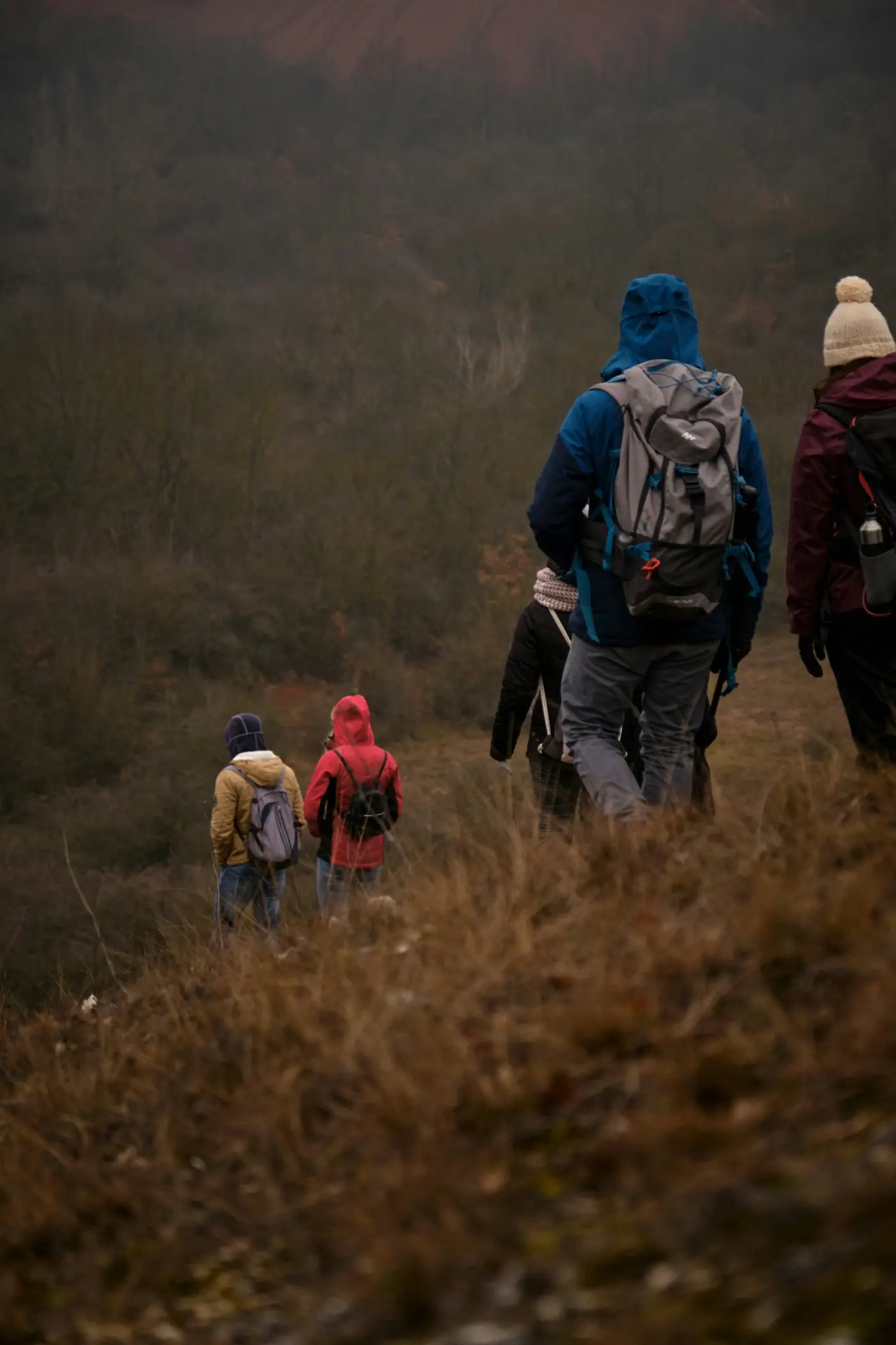 A group of friends walking down a dirt road together